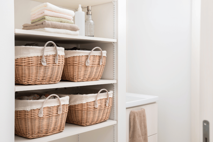 Storage bins on shelves in closet room for organization 