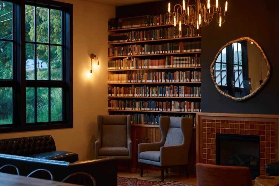 bookshelves on the back wall of a sitting room filled with books