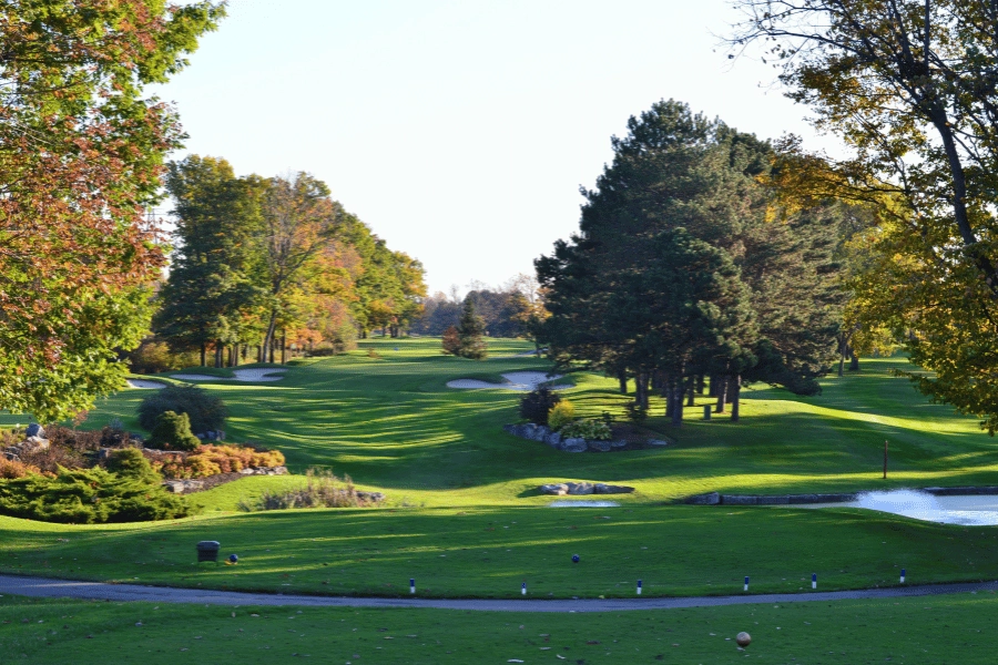 Pretty golf course with sand pits and trees turning color in the fall