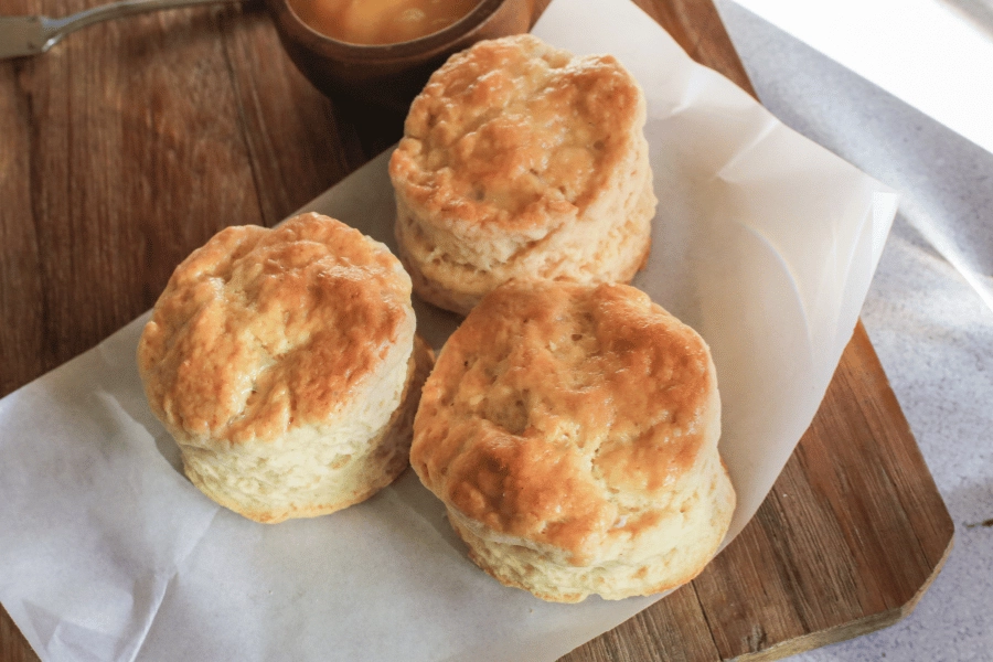 three southern flaky biscuits on parchment paper