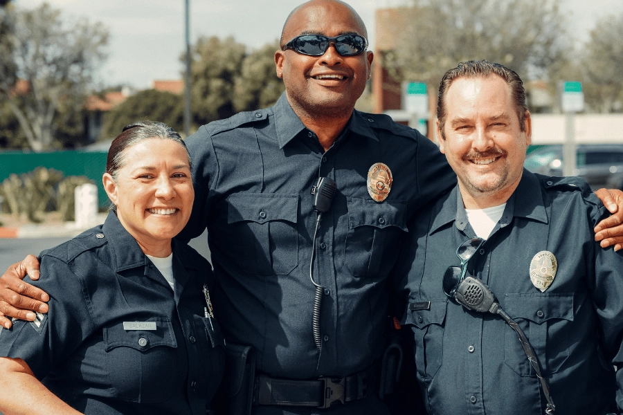 three cops standing together smiling and happy 