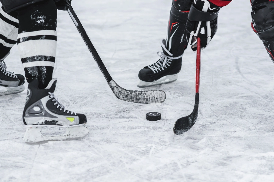 two hockey players getting ready to hit the puck on the ice