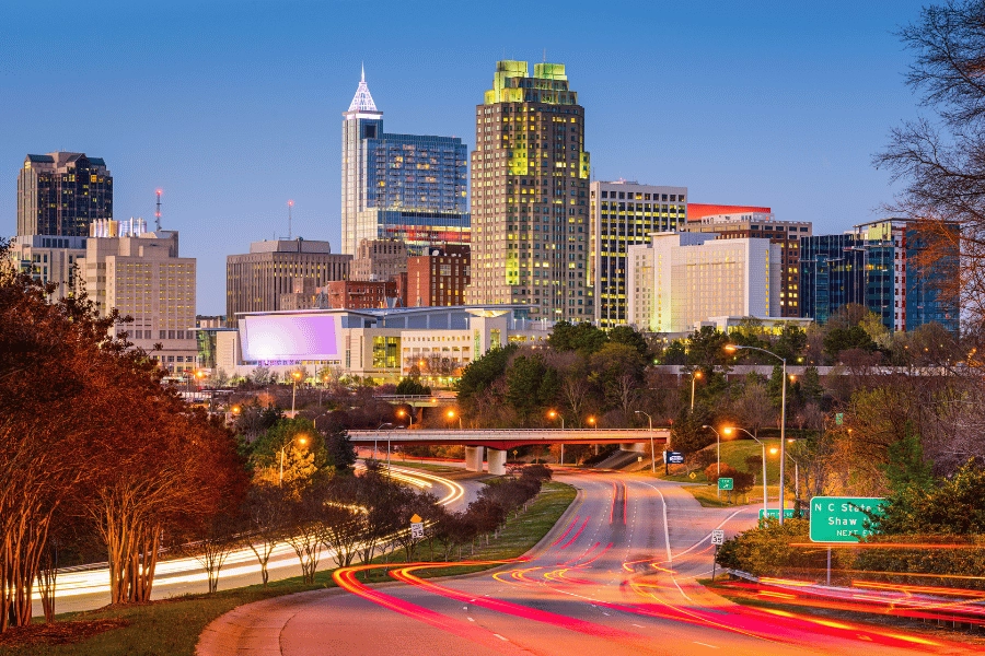 Raleigh, NC, skyline at dusk with car and city lights