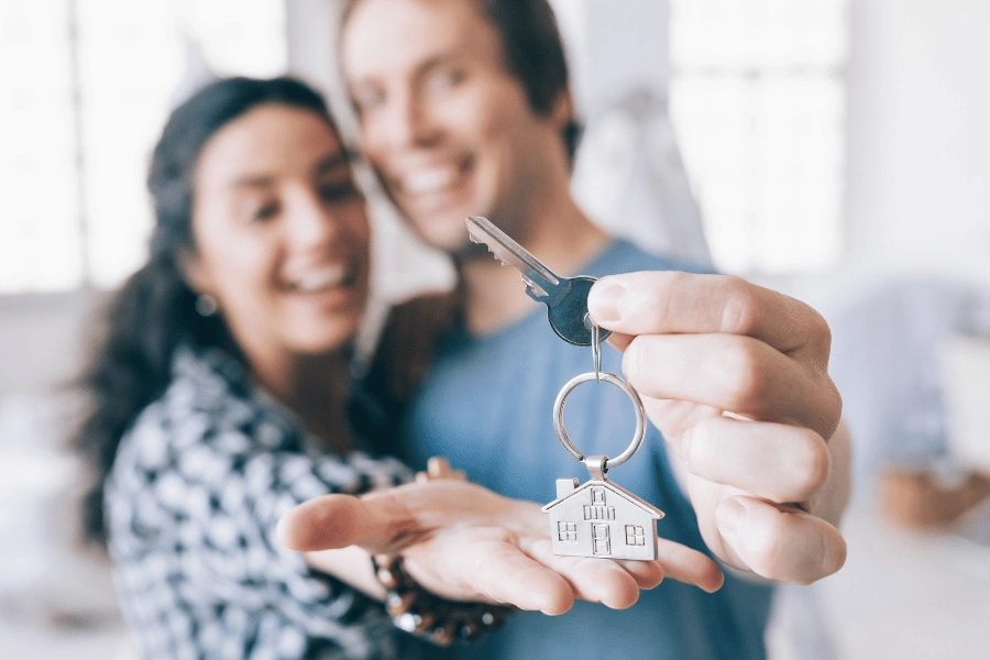 homeowners holding keys to new home