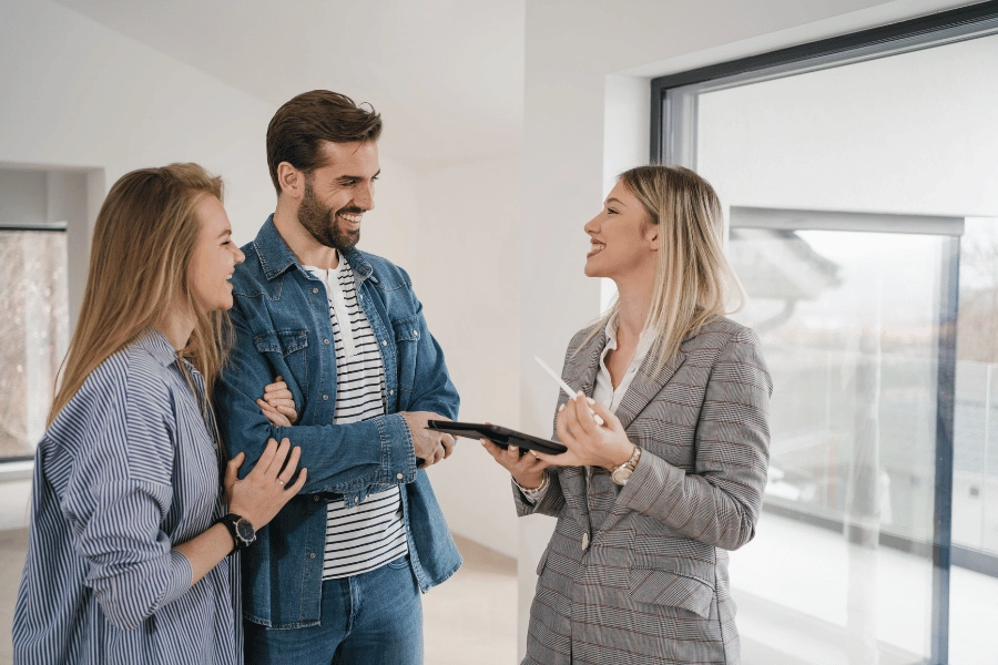 real estate agent helping clients and showing a house