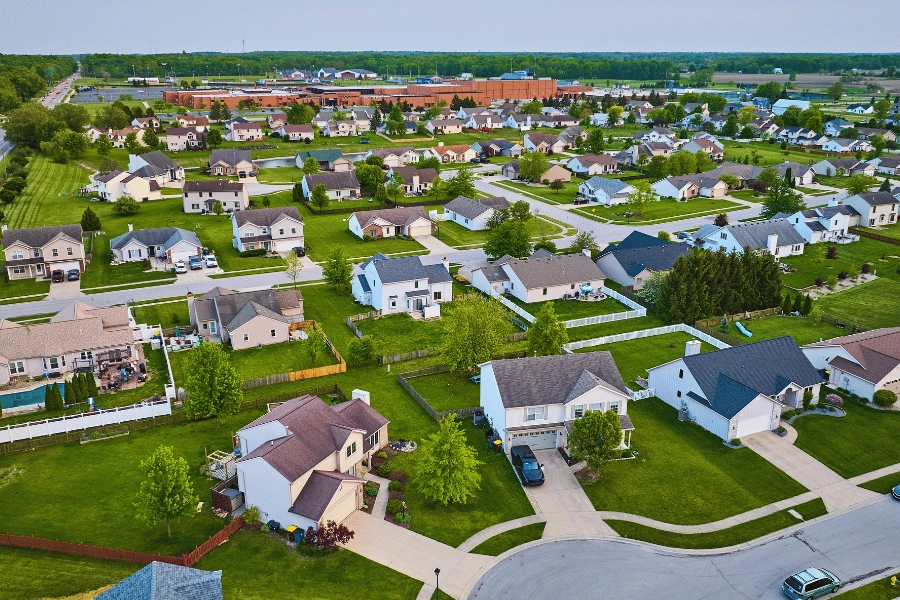 aerial view of suburban homes surrounded by trees