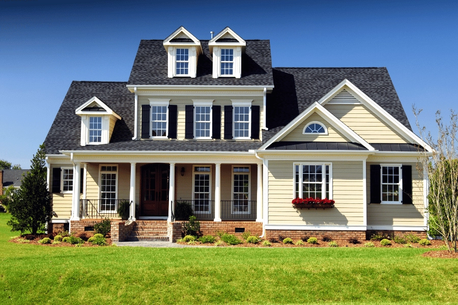 beautiful well-maintained home in an HOA community with front porch and fresh cut grass