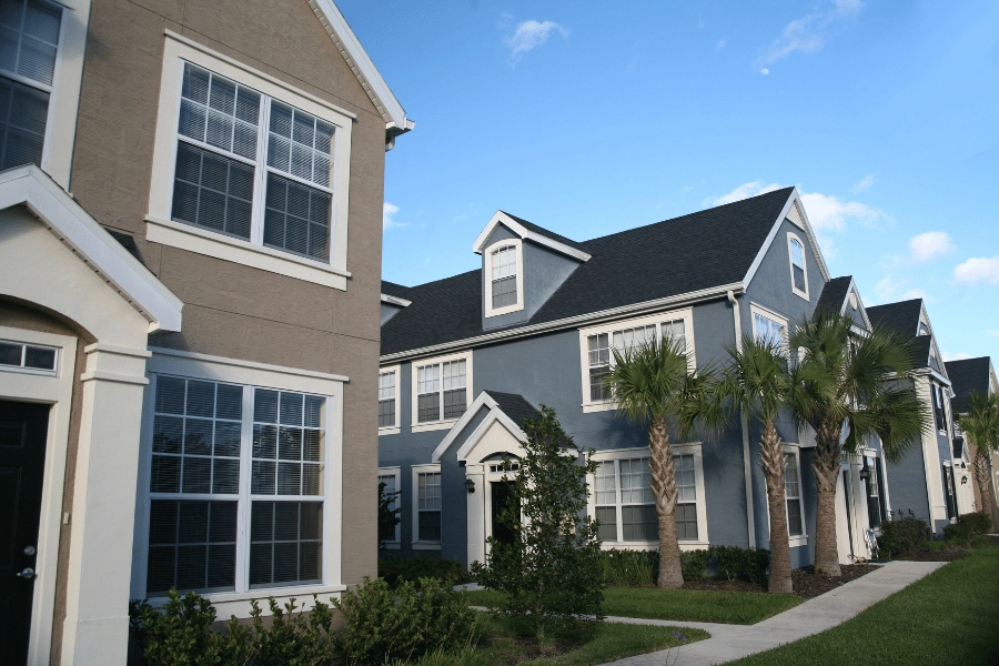 HOA community with colorful homes and palm trees