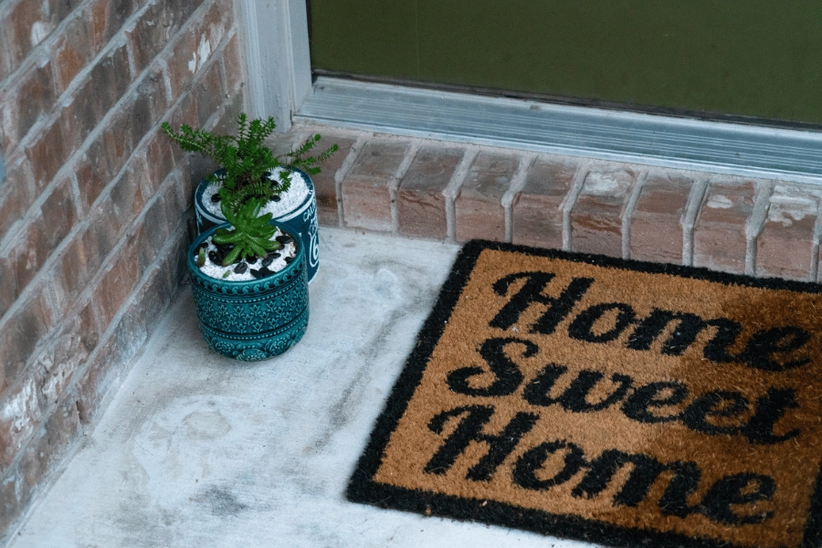 home sweet home welcome mat with plants 
