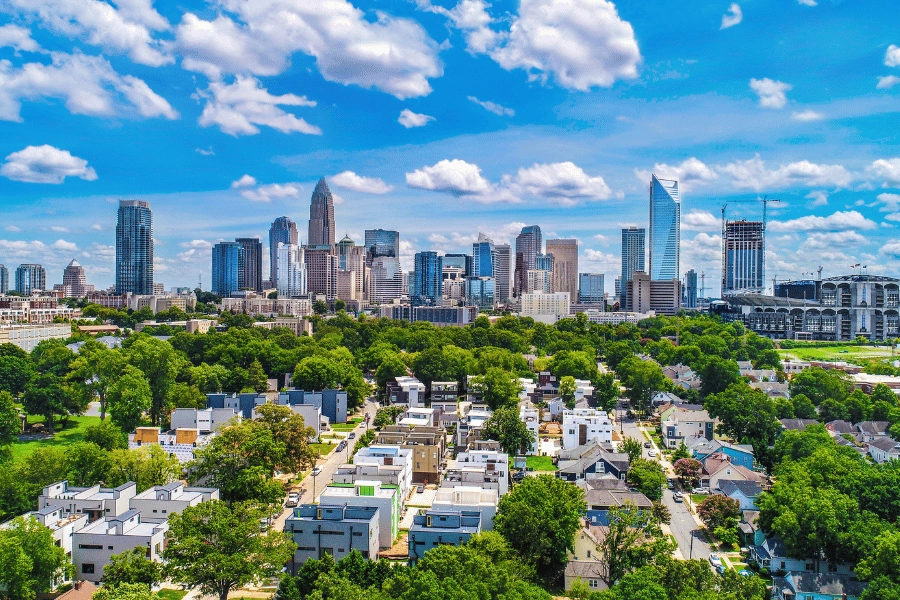View of Downtown Charlotte, NC, and its many tall buildings on a sunny day