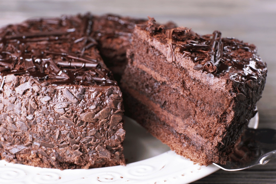 plate of chocolate cake decorated with chocolate shavings