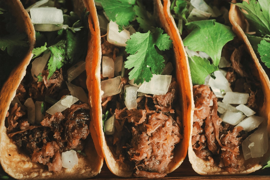 authentic Mexican tacos topped with onion and cilantro