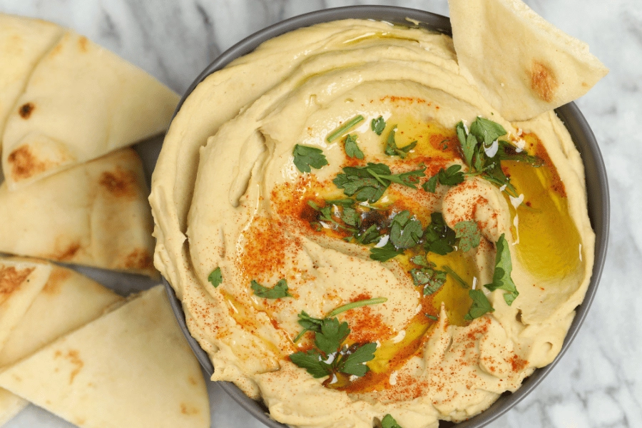 bowl of fresh hummus with pita bread 
