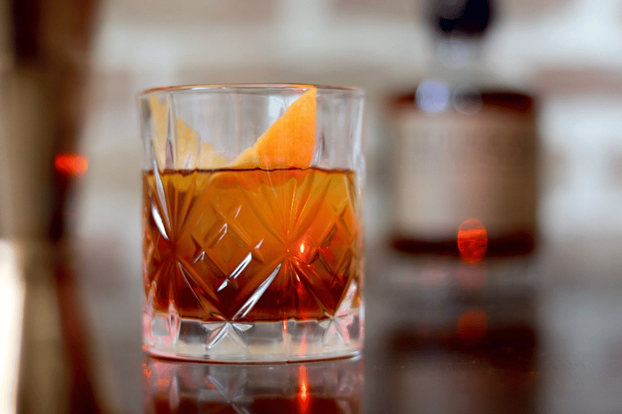 old fashioned cocktail in a glass with orange slice