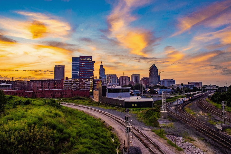 sunset view of Downtown Raleigh overlooking railroad tracks