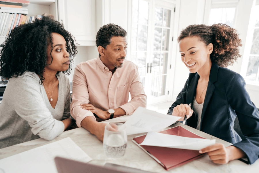 clients working and talking with a real estate agent 