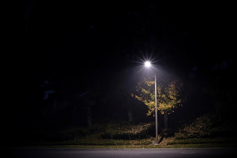 single street light illuminating a dark street at night