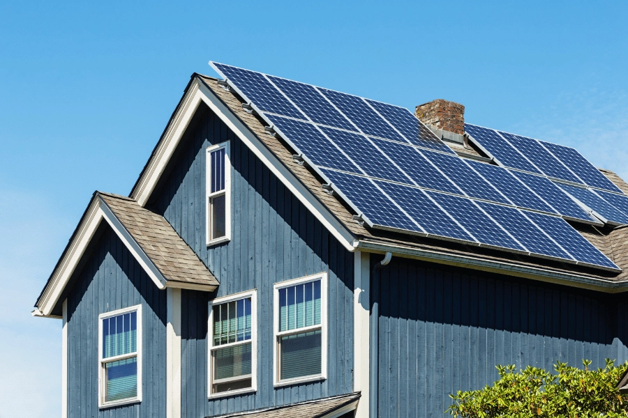 solar panels on the roof of a blue home 