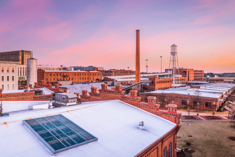 pink sunset over Downtown Durham and its many brick buildings in NC