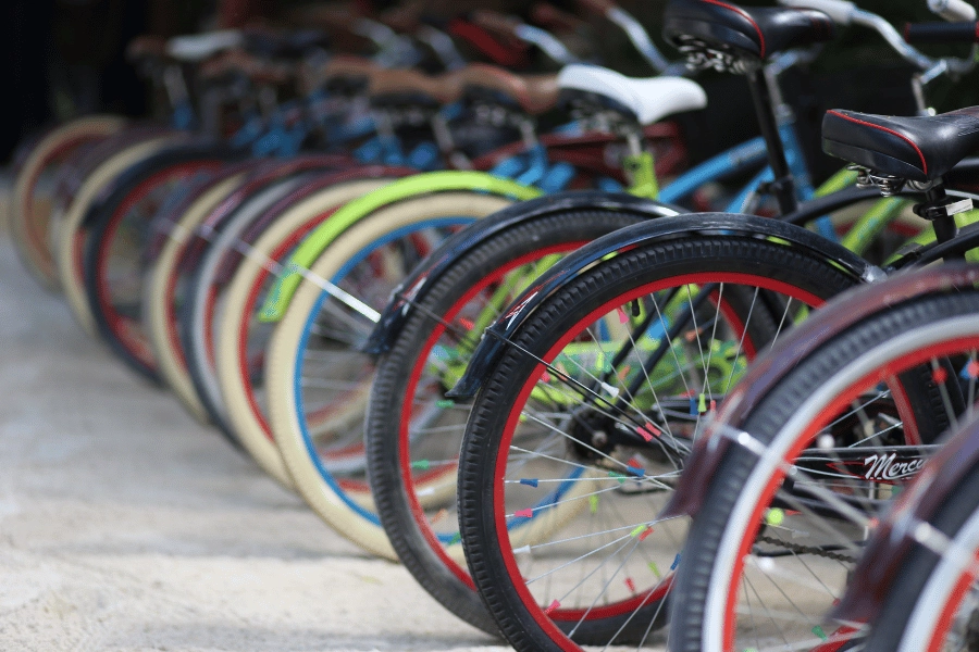 different colored bikes lined up and parked next to each other