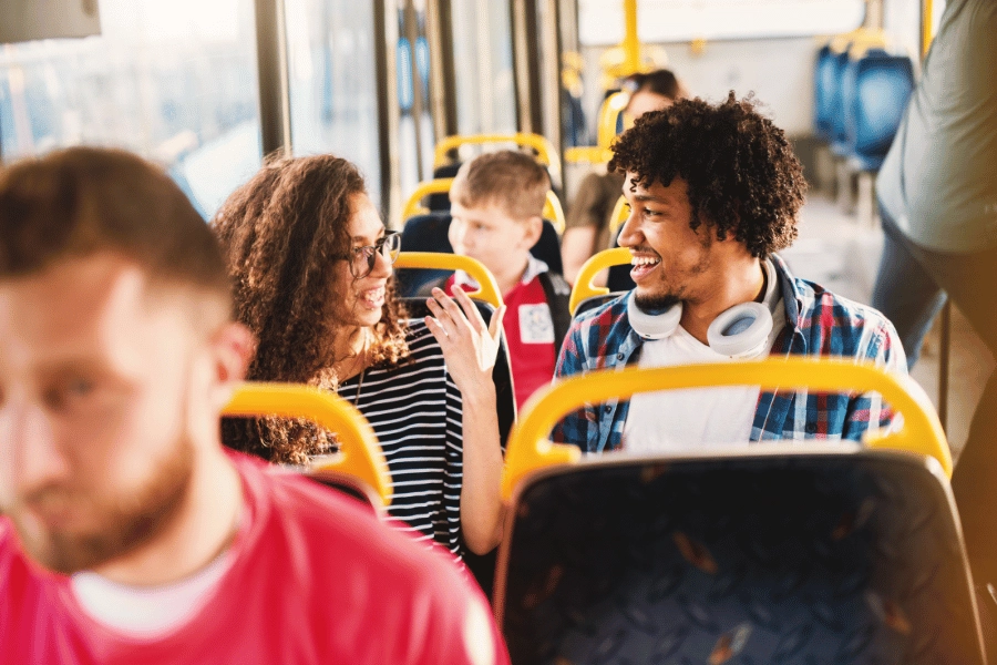 people talking and riding on a public bus 