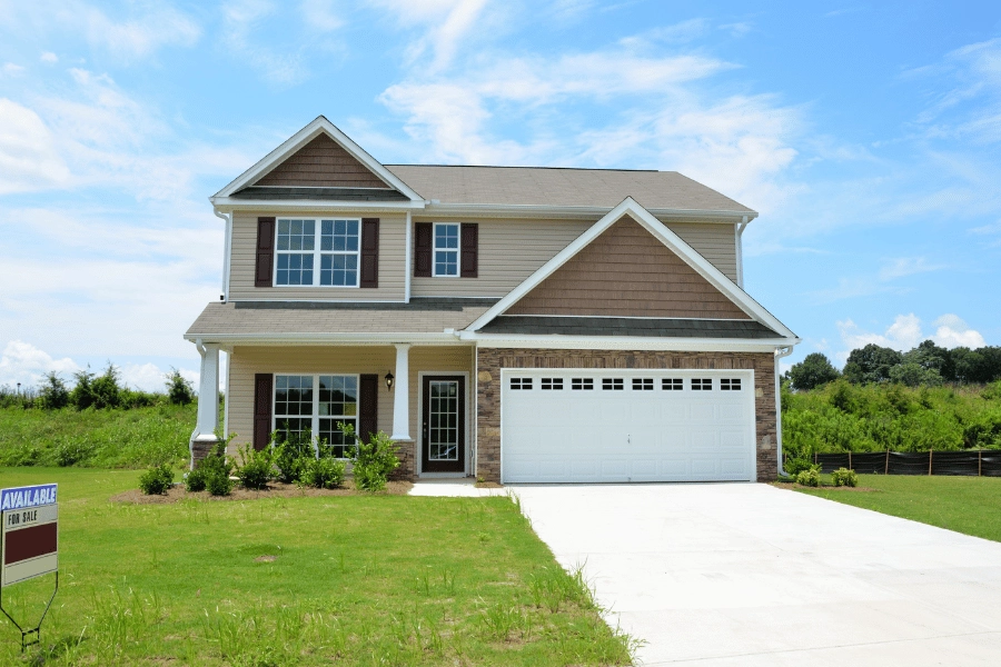newly built home with driveway and two car garage 