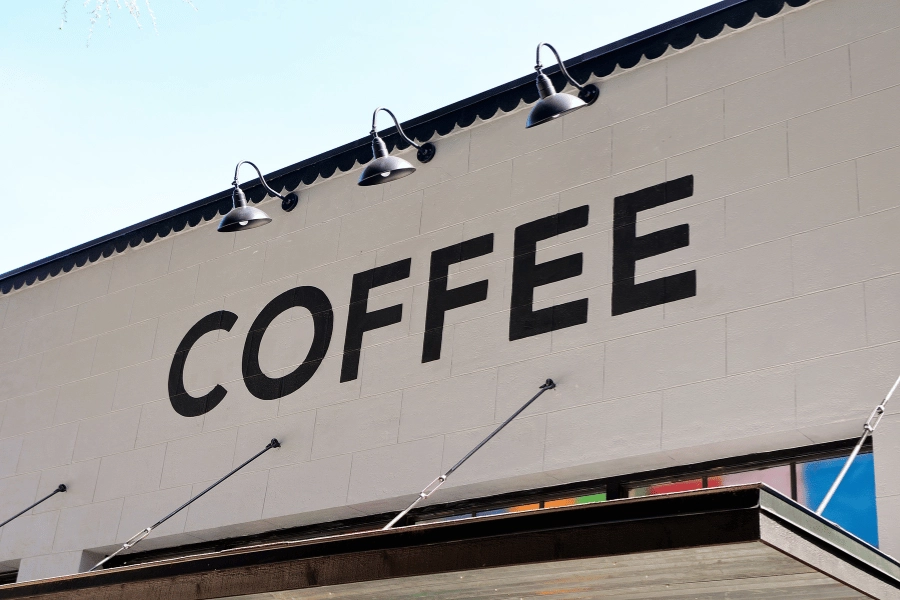 white brick coffee shop with coffee sign