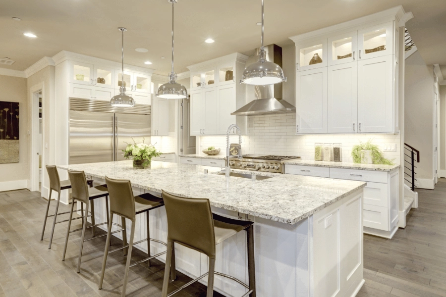 new kitchen in a large home with granite countertops and kitchen island