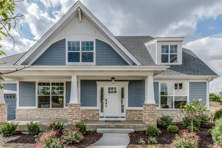 blue single-family home with front porch and nice landscaping