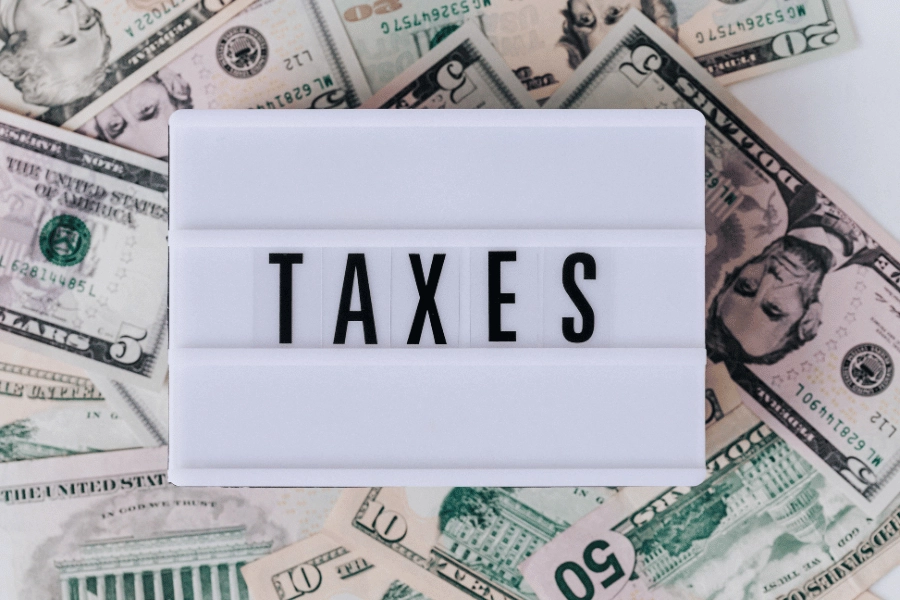 taxes sign with a bunch of cash 