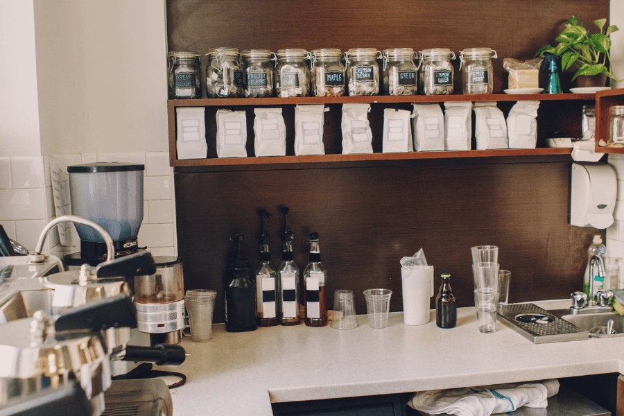 organized tea and coffee on a shelf at a coffee shop