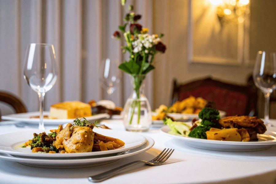 plates full of food on a white tablecloth at a fine dining restaurant