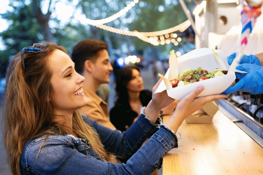 woman getting her food at a food truck 