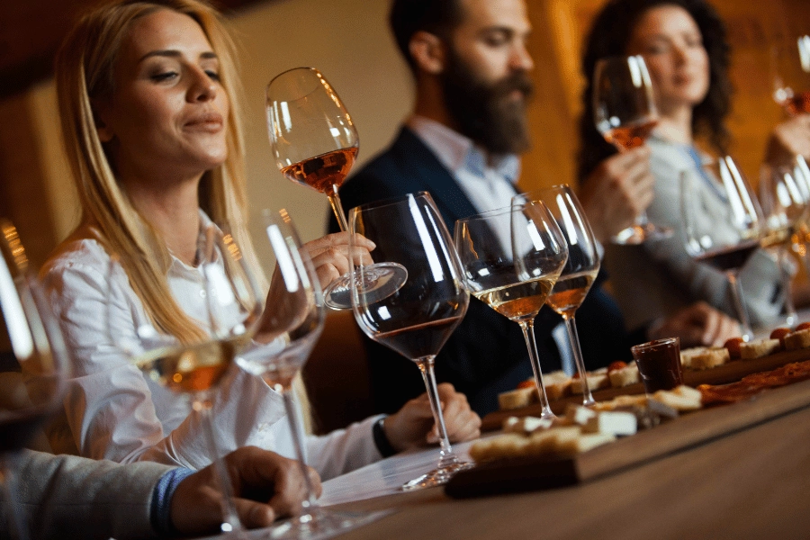 group of people enjoying a wine tasting at a winery