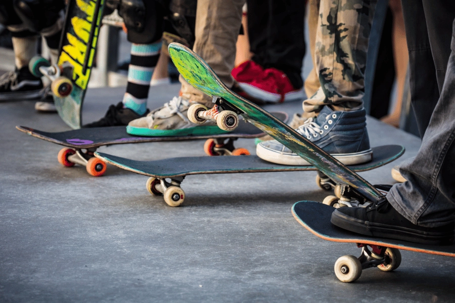 group of skateboarders at a skate park on their skateboards