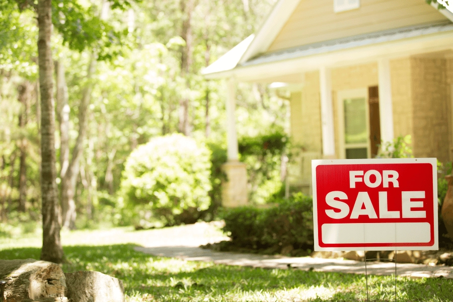 red for sale sign in the front yard of an inherited property