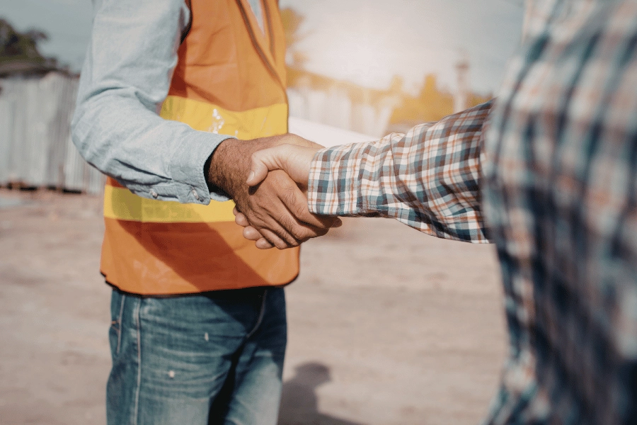 selling an inherited property to a builder as-is and shaking hands with the builder