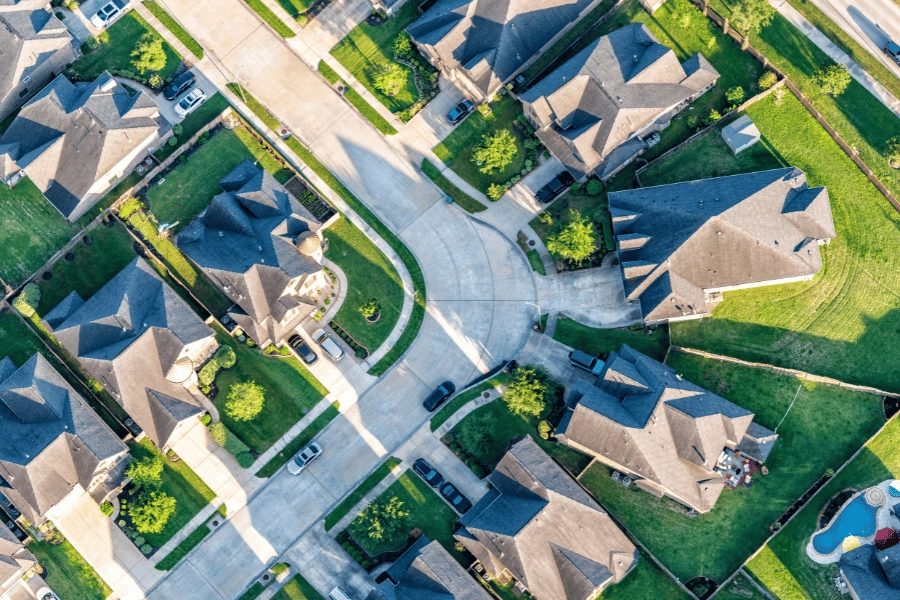overlooking a suburban subdivision with single-family homes and cars parked in driveways
