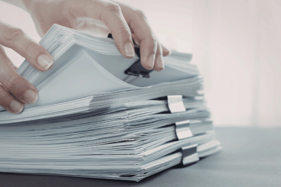 person preparing stacks of documents when selling home as-is to builder