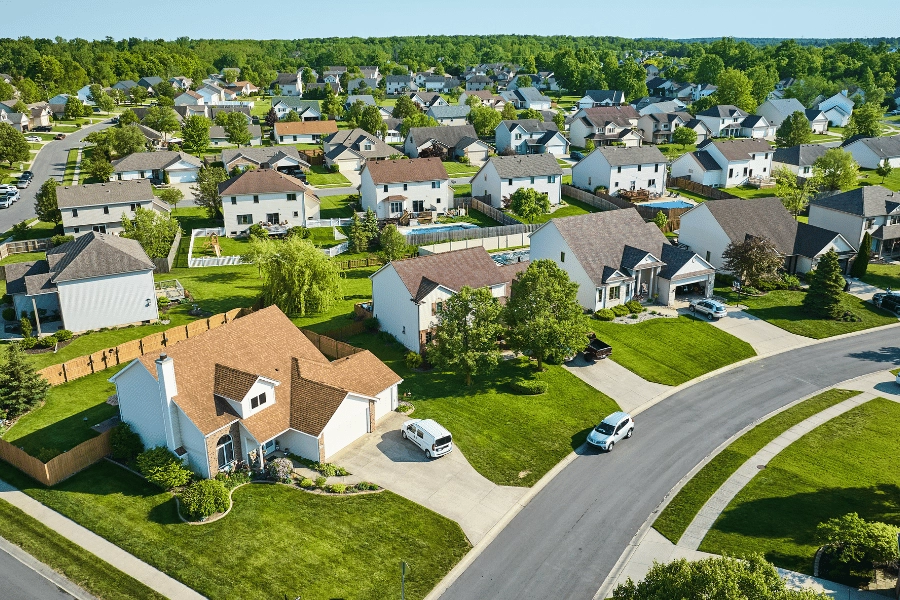 overlooking a suburban neighborhood with large lots and driveways