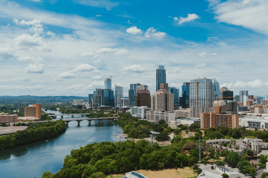 river near tall city buildings during daytime